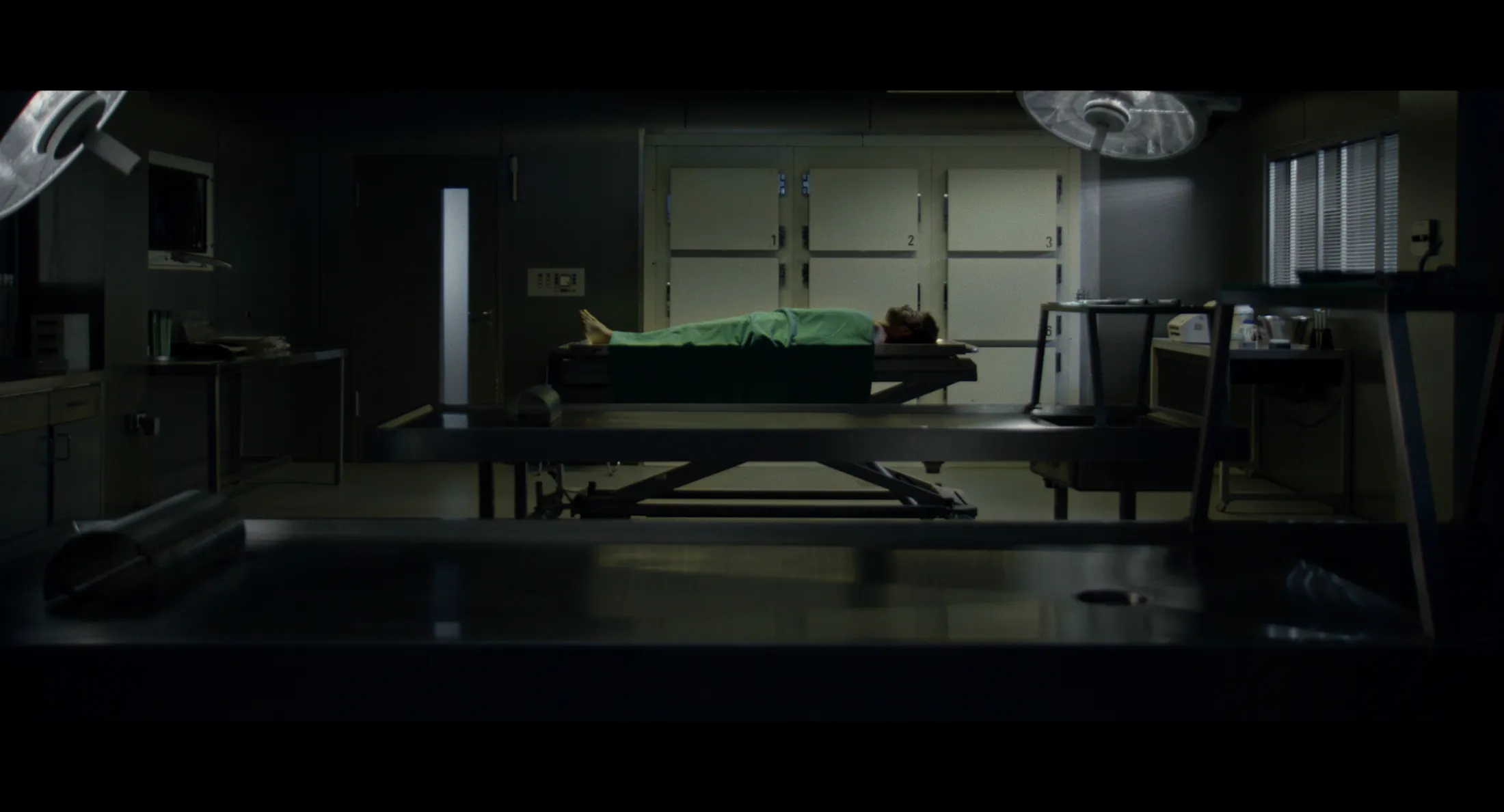 Film still from “Eho” showing a scene inside a mortuary