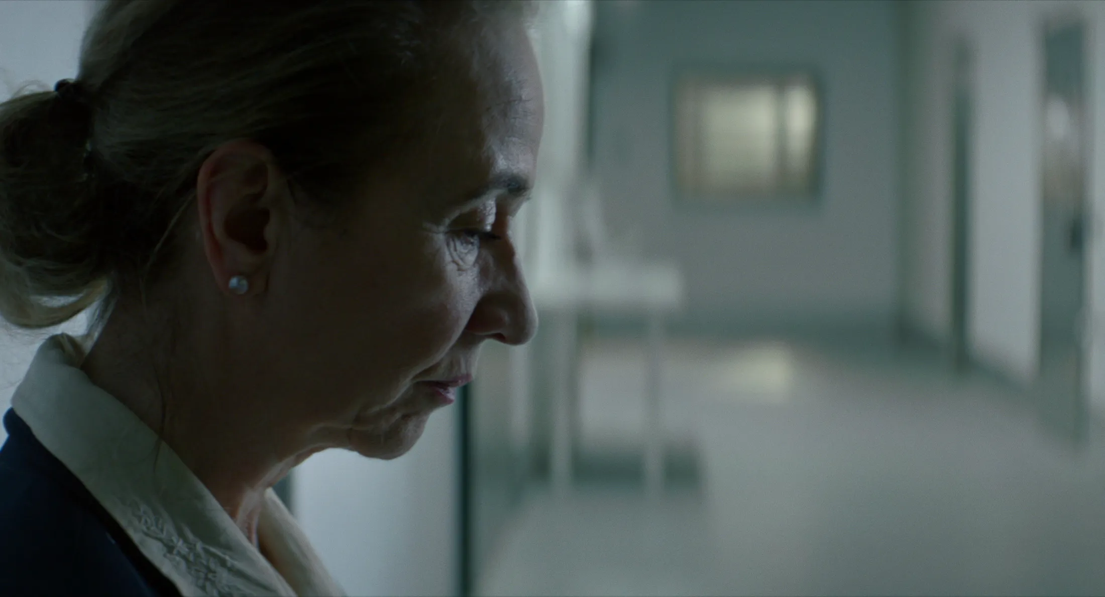 Film still from “Eho” showing Klara Höfels in close-up in hospital