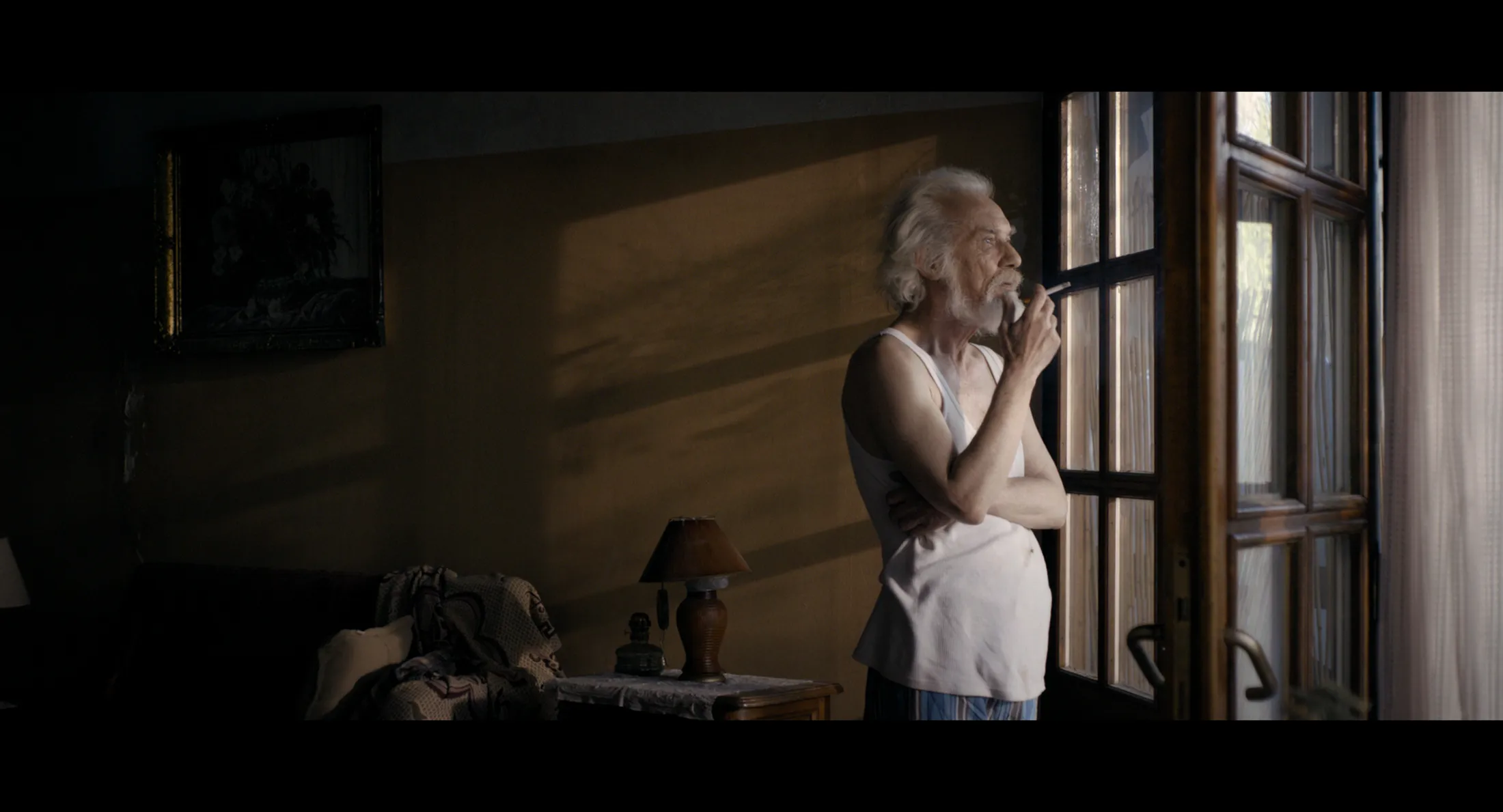 Selman Jusufi stands at the window and smokes