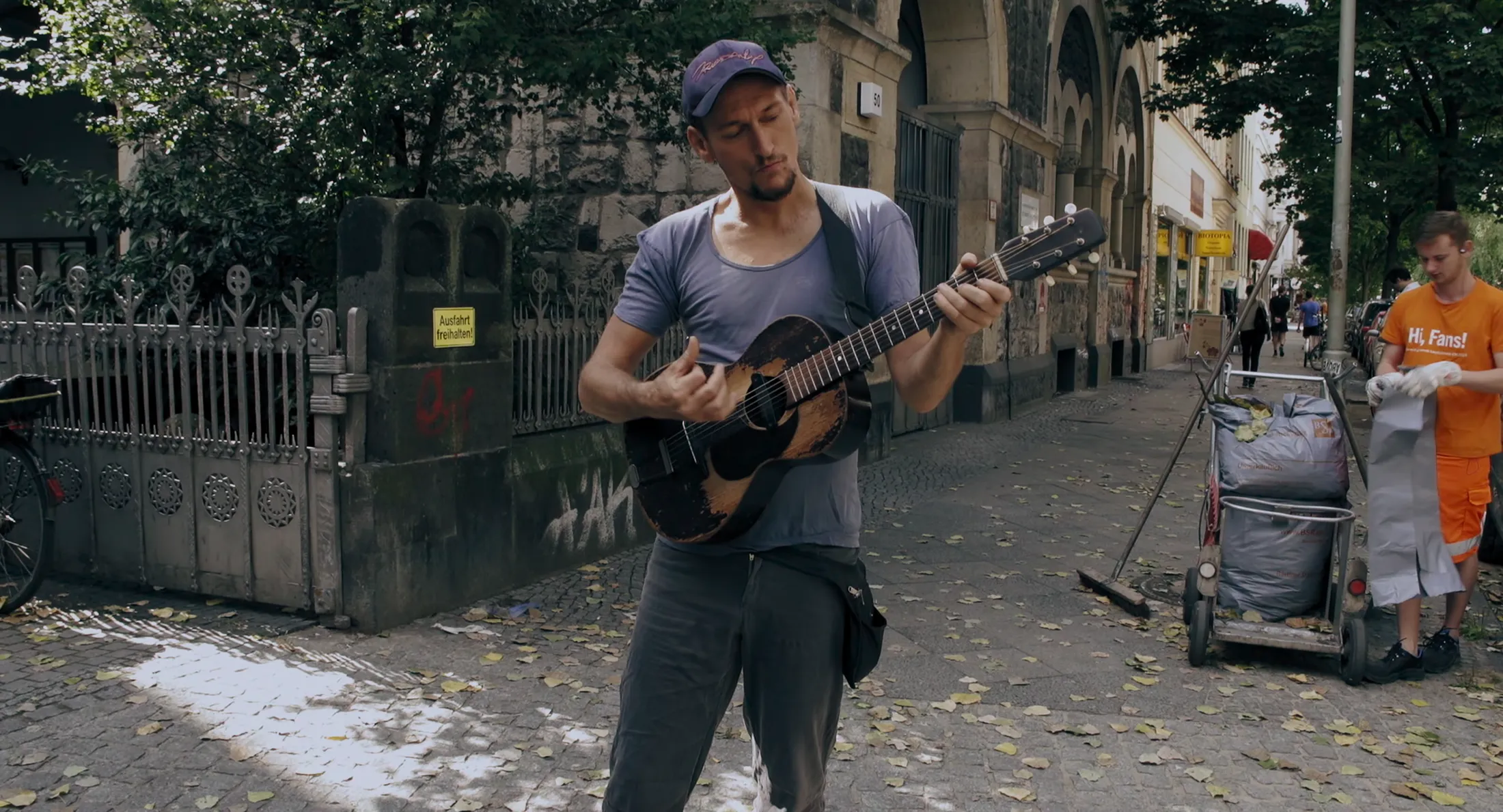 A street musician wanders through the Wrangelkiez neighbourhood